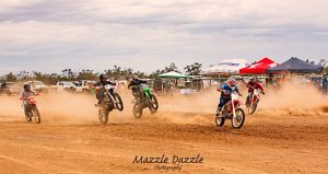 Dirt bike riders racing on a track