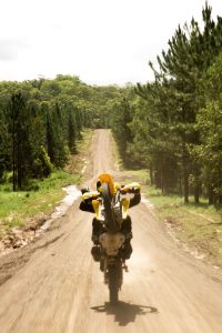 A dirt bike rider doing a wheelie on the Sunshine Coast