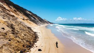 A drone image of a dirt bike rider on Rainbow Beach