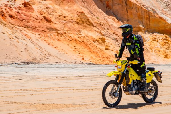 Person Riding Dirt Bike On Sand